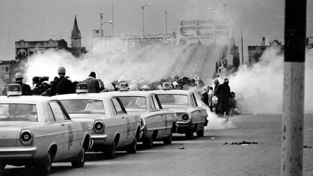 In this March 7, 1965 file photo, clouds of tear gas fill the air as state troopers, ordered by Gov. George Wallace, break up a demonstration march in Selma, Ala., on what became known as "Bloody Sunday." The incident is widely credited for galvanizing the nation's leaders and ultimately yielded passage of the Voting Rights Act of 1965. (AP Photo/File