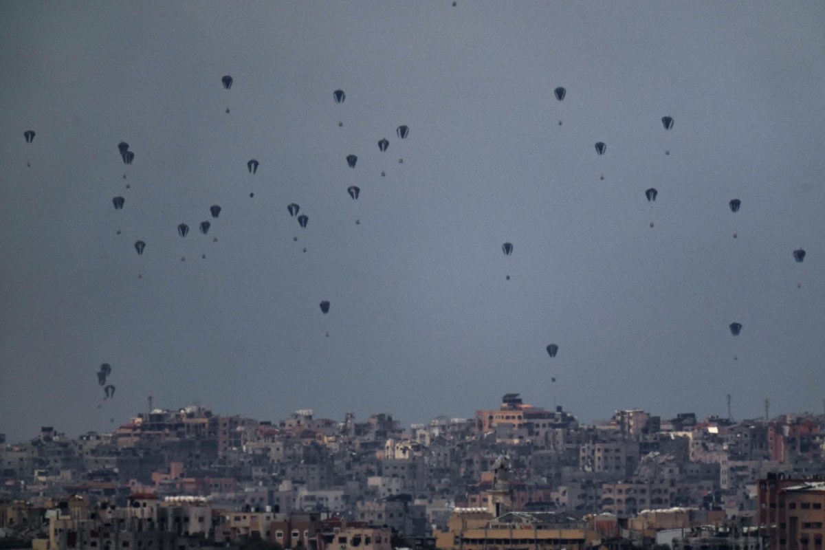Parachutes drop aid into the northern Gaza Strip, as seen from southern Israel, Friday, March 8, 2024. (AP Photo/Leo Correa)