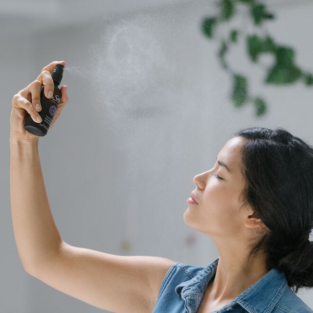 Person misting their face with Lavender Mist
