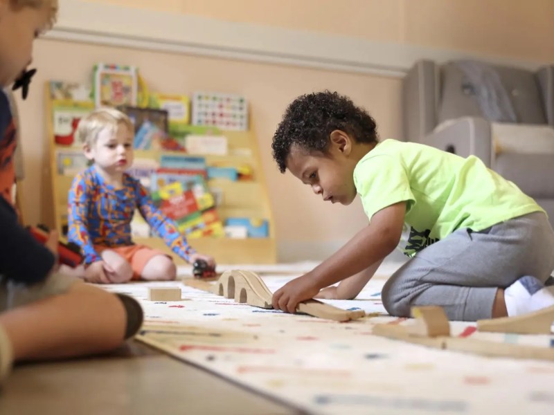 Elijah Rollings, 2, plays with a train set at Bumble Art Studio day care center in Astoria, Ore., Friday, Sept. 2, 2022.