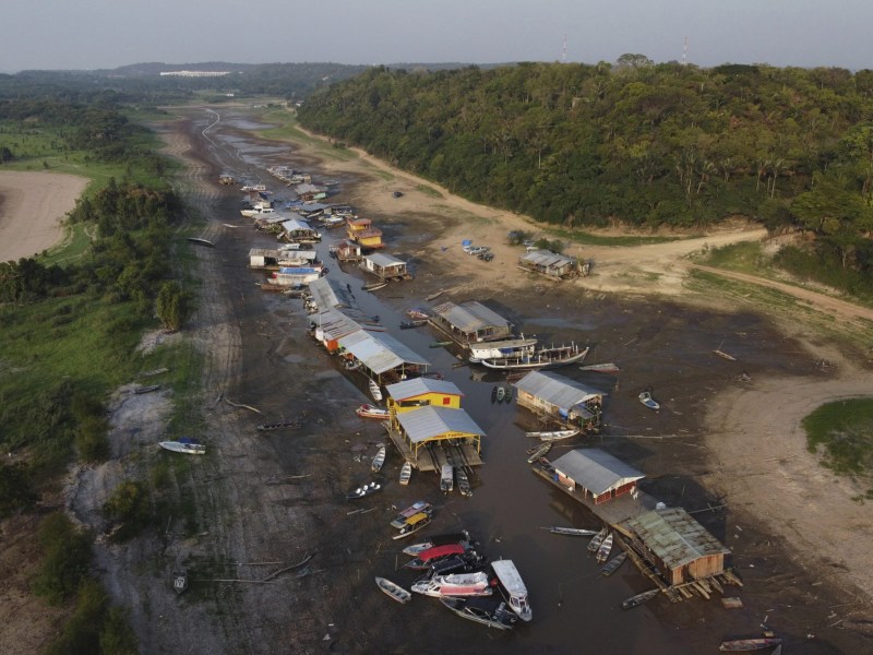 Floating homes and boats lay stranded on the dry bed of Puraquequara lake, amid a severe drought, in Manaus, Amazonas state, Brazil, Oct. 5, 2023. (AP Photo/Edmar Barros)