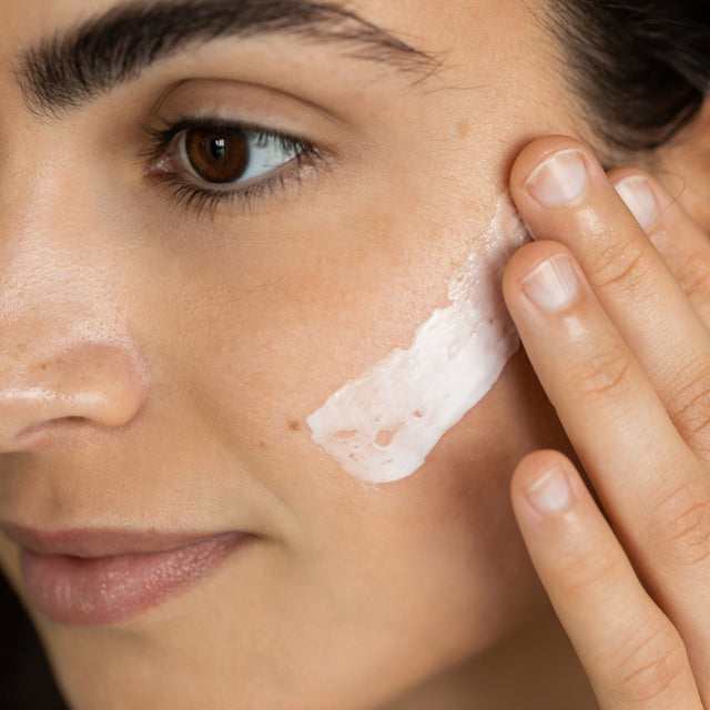 Person applying Saje Glow On Moisturizer on face