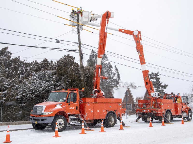 Oklahoma Gas and Electric utility trucks during winter storm.