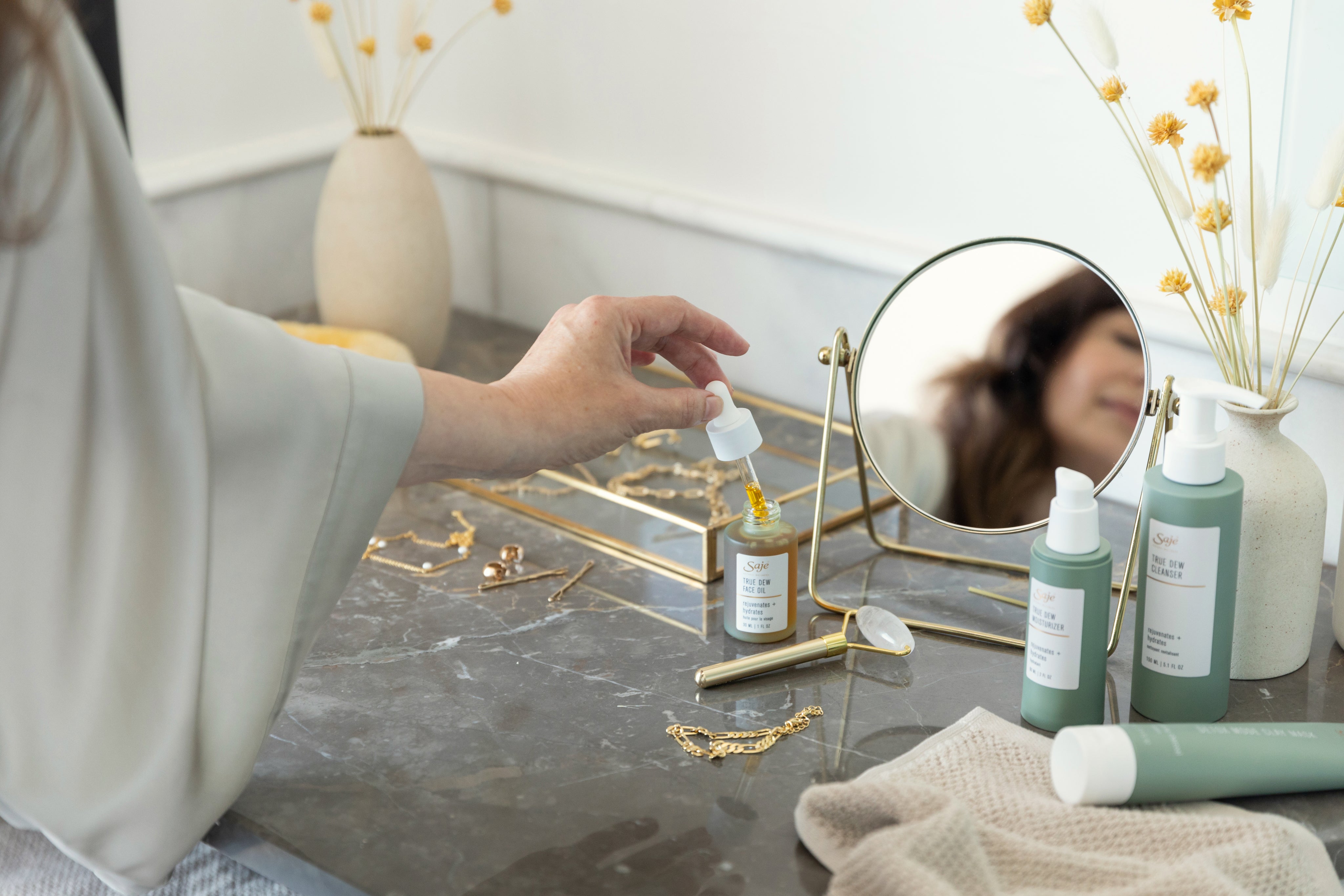 True dew skincare collection on a bathroom counter