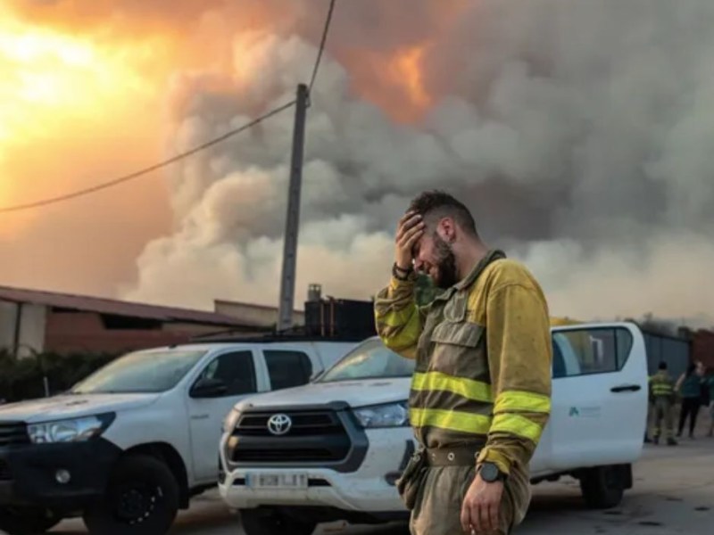 Fire fighter battles wildfire in Spain amid global heat wave